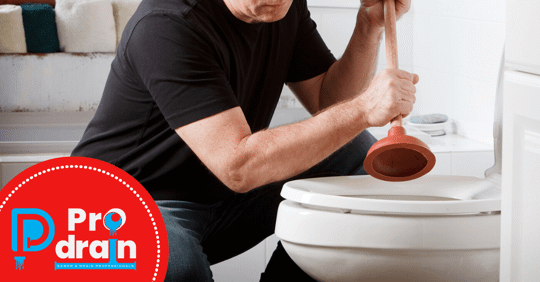 Picture of man plunging toilet